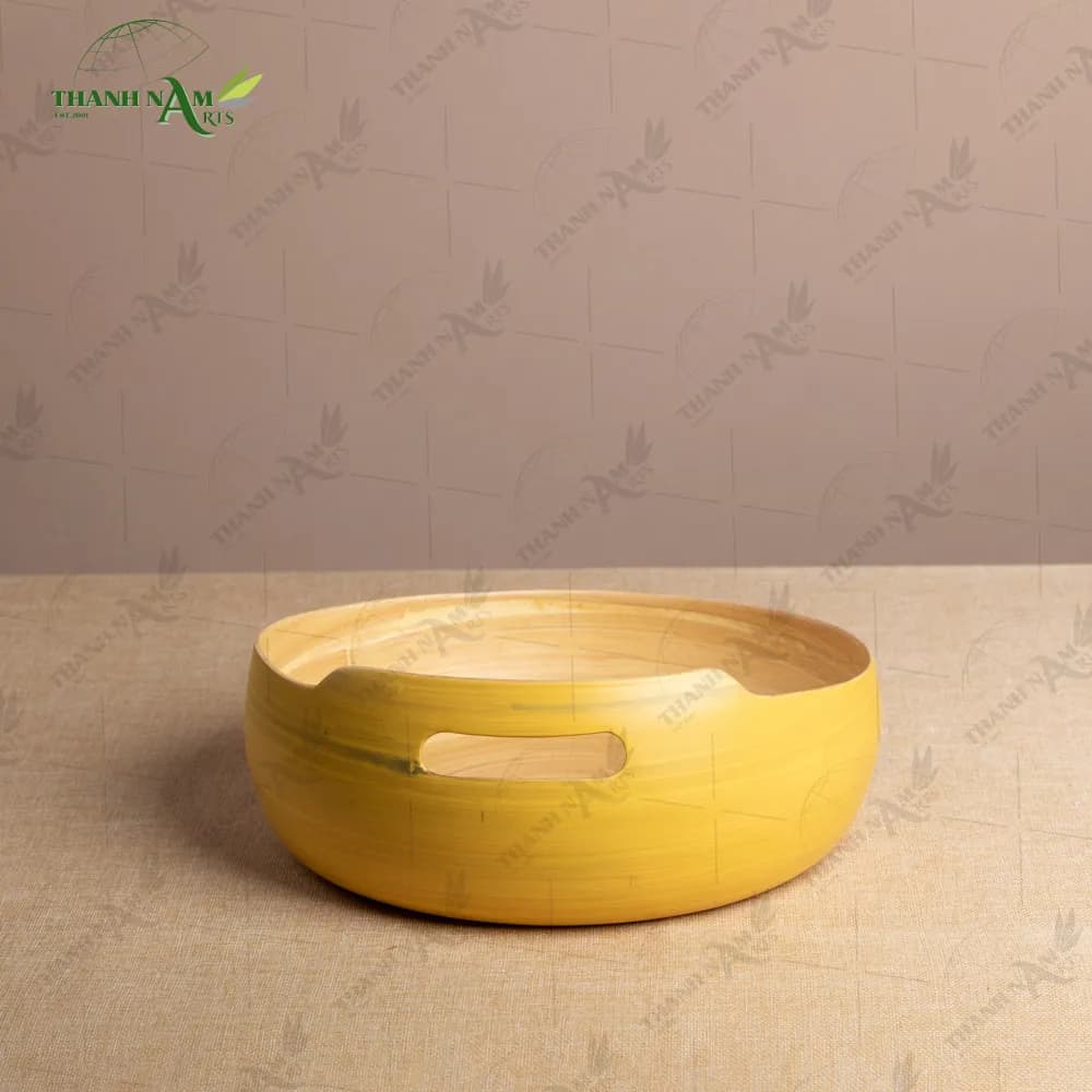 Yellow lacquered bamboo bowl with handle cutouts
