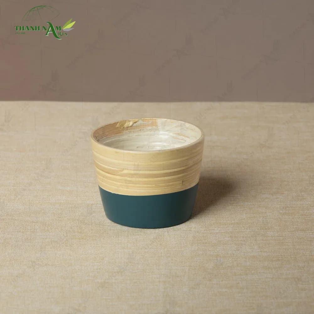 Bamboo planter pot with a dark green base