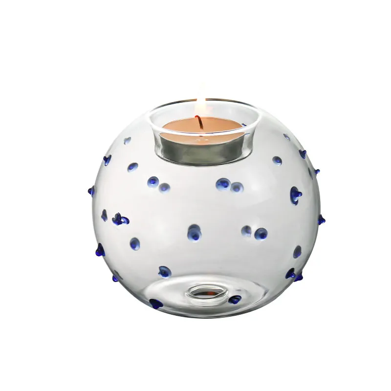 Clear spherical glass tealight holder with blue dots