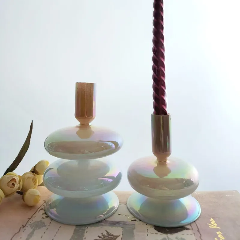 Pearlescent glass candlestick holders with a twisted red candle