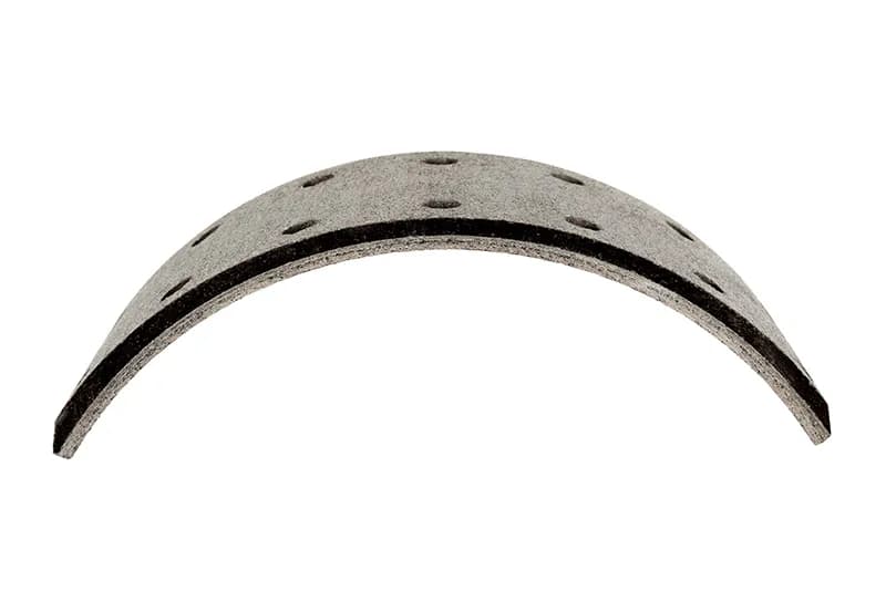 Long curved brake lining block on a white background