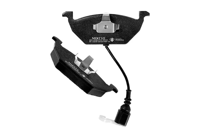 Front and rear disc brake pads with a wire lead on a white background