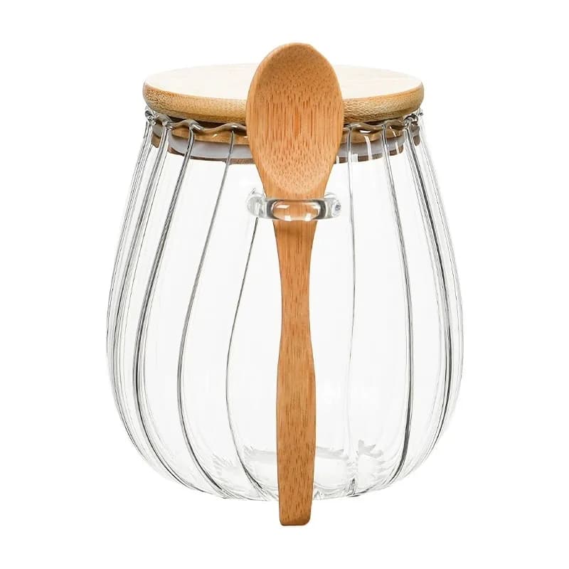 Ribbed glass jar with a wooden lid and spoon